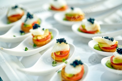 Preview: Delicious tartlets with black caviar. Concept of food, restaurant, catering, menu.