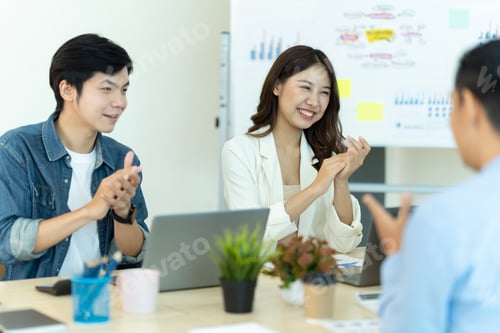 Preview: Business people showing team work while working in board room in office interior.
