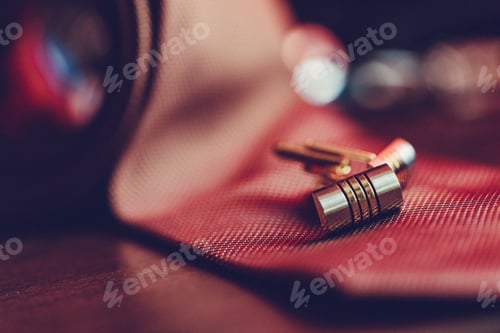 Preview: Stylish cufflinks resting on a textured surface, showcasing intricate design and elegance during an