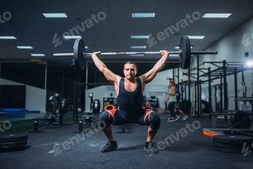 Preview: Strong powerlifter doing deadlift a barbell in gym