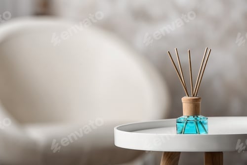 Preview: Reed air freshener on white table indoors, space for text
