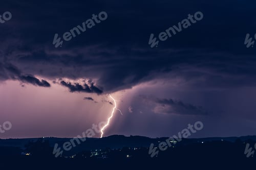 Preview: Night landscape on a background of thunderstorms. Rural silhouette and clouds with lightning flashes