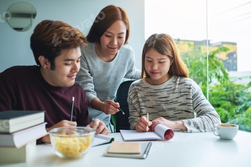 Preview: Group of young students tutoring and catching up workbook together