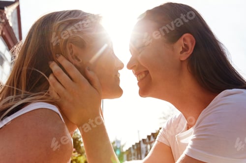 Preview: Female Gay Couple Outside House About To Kiss Against Flaring Sun