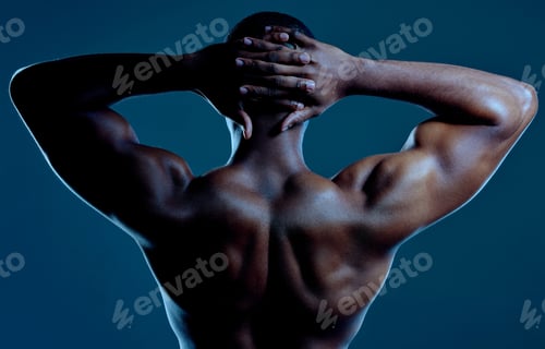 Preview: Rearview studio shot of a fit young man posing against a black background