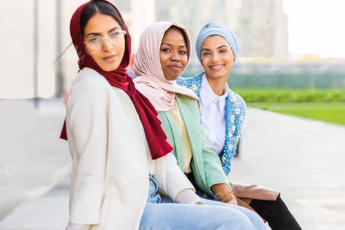 Preview: Three Women Stylishly Dressed Seated Together Outside