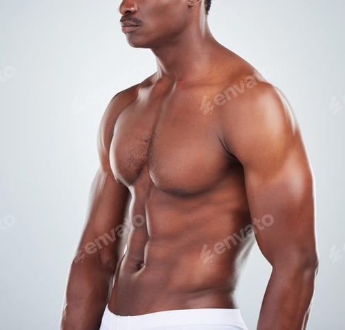 Preview: Closeup of one African American fitness model posing topless in a underwear and looking muscular.