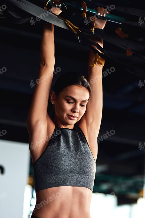 Preview: Functional training. Vertical shot of a young attractive sportive woman exercising on horizontal bar