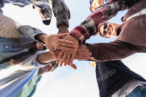 Preview: Unity in Diversity - multiethnic people joining hands together
