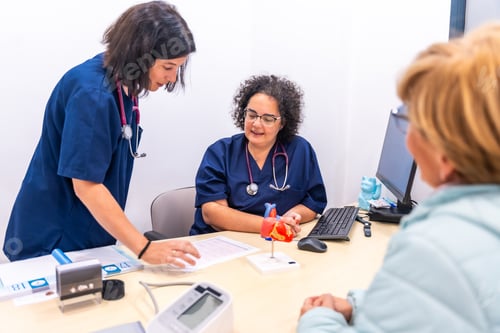 Preview: Nurse showing an analysis to the cardiologist doctor in the cardiology clinic together with a client