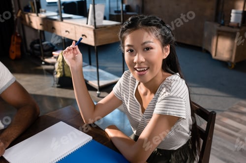Preview: beautiful asian student girl with blank notebook looking at camera