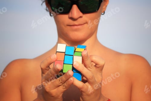 Preview: Woman playing with mini rubik cube