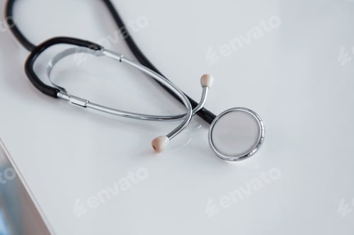 Preview: Close up view of medical stethoscope that lying down on white table