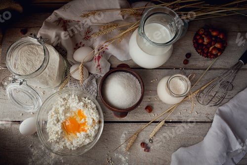 Preview: Fresh dairy products. Milk, cottage cheese, sour cream and wheat on rustic wooden background.