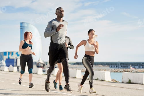 Preview: Group of sportspeople jogging at harbour