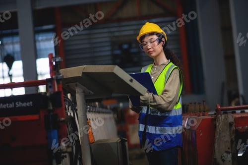 Preview: Female engineer working in a factory.