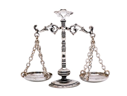 Preview: Silver scales of justice balancing on white background