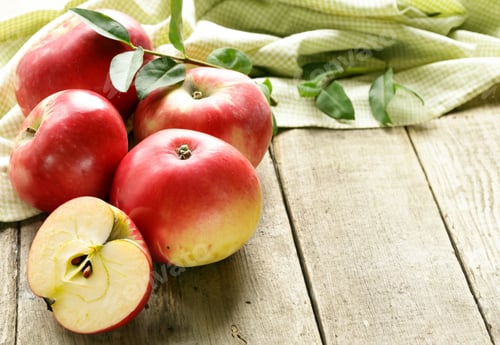 Preview: organic red apples on wooden table