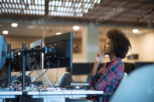 Preview: young black woman at her workplace in modern office
