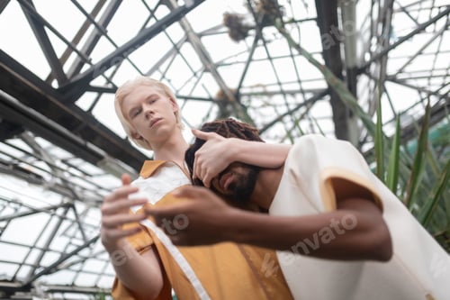 Preview: Two male models posing in greenhouse with glass ceiling