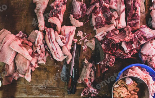 Preview: meat raw assortment and knife on the butcher's dark wooden worki