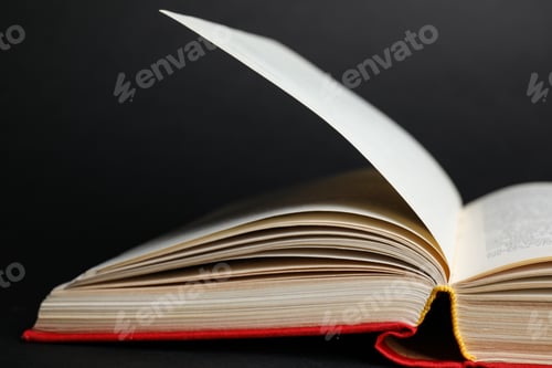 Preview: Closeup view of open book on black background