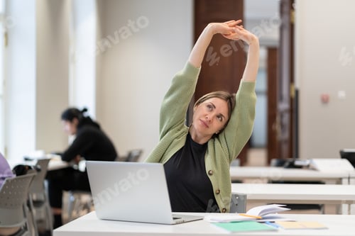 Preview: Middle-aged woman student warming up body and muscles at classroom, feeling satisfied with work done
