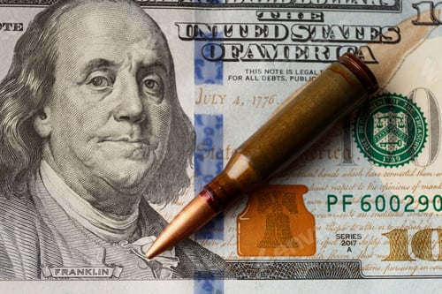 Preview: Bullets lie on American dollar bills, arms trade