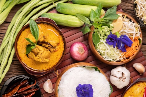 Preview: Rice noodles in a bowl of curry paste with chili, cucumber, long bean, lime, garlic and spring onion