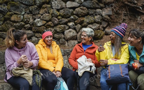 Preview: Multiracial women with different ages resting and having fun together during trekking day