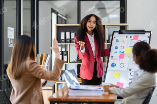Preview: A group of young American businesswomen pointed to a whiteboard to provide information and a portfol