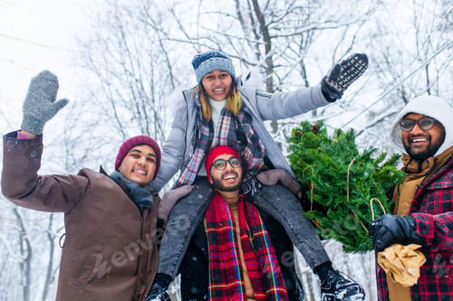 Preview: Outdoor lifestyle portrait of four best friends carrying the tree to home