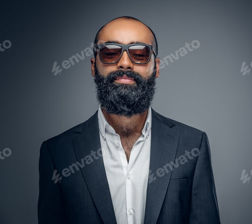 Preview: A man in a suit and sunglasses isolated on grey background.