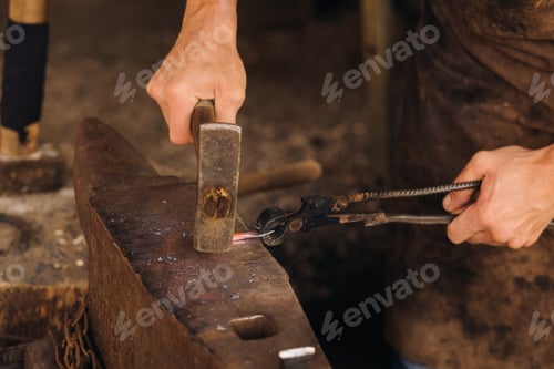 Preview: A blacksmith manually forges red-hot metal on an anvil with a hammer