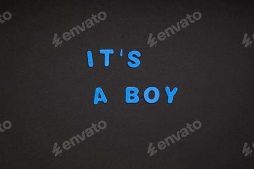 Preview: It's a boy writing on black paper background