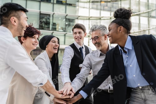 Preview: Multiracial business teamwork with their hands together showing unity