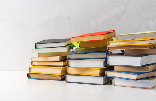 Preview: pile of paperback books on a table