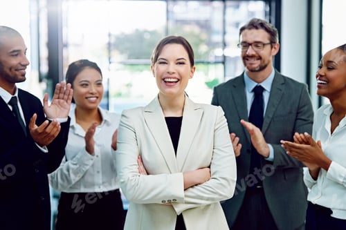Preview: Portrait of a succesful businesswoman being applauded by her colleagues in the office