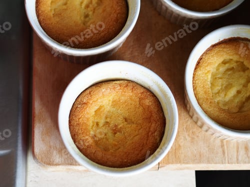 Preview: Corn flour sweet muffins in baking ramekins on wooden board