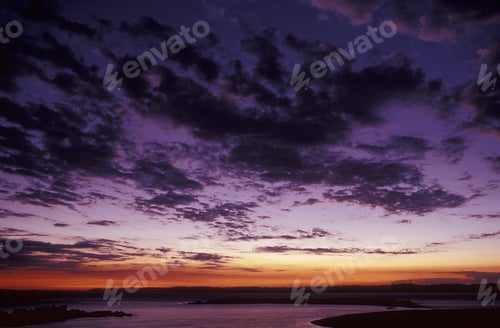 Preview: Beautiful shot of a purple sky with clouds above the sea at sunset