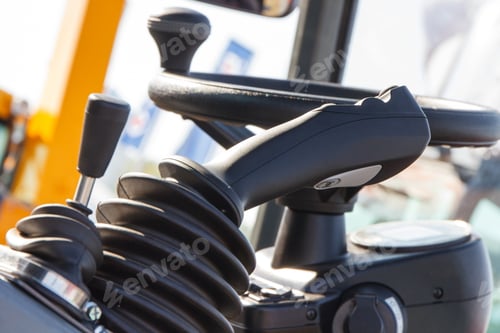 Preview: Operating control panel with buttons and steering wheel in industrial agricultural machine