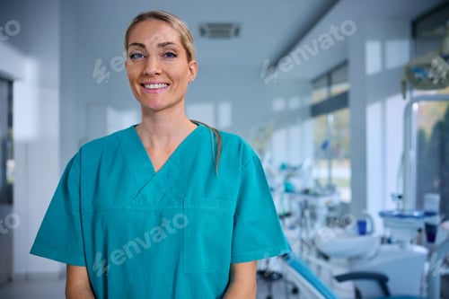 Preview: Happy female dentist at dental clinic looking at camera.