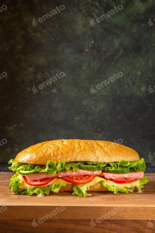 Preview: Vertical view of delicious homemade sandwich on wooden cutting board on black distressed background