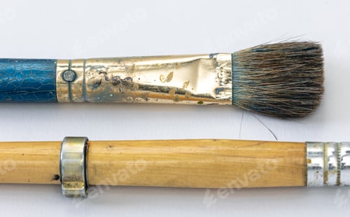Preview: Close-up, old paint brushes on a white background.