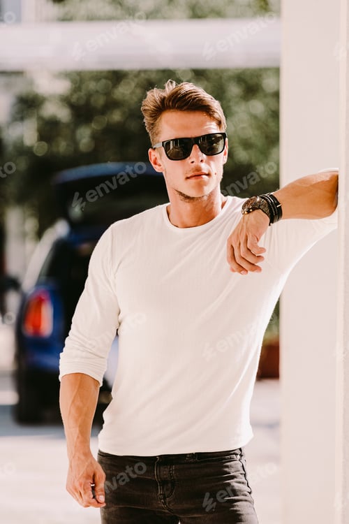 Preview: portrait of a brutal man in sunglasses and watch outdoors