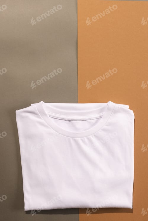 Preview: Close up of folded white t shirts and copy space on brown background