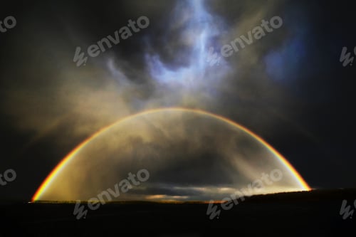 Preview: The arc of a rainbow over the landscape.