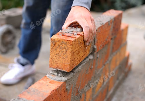 Preview: Person laying bricks to create a wall