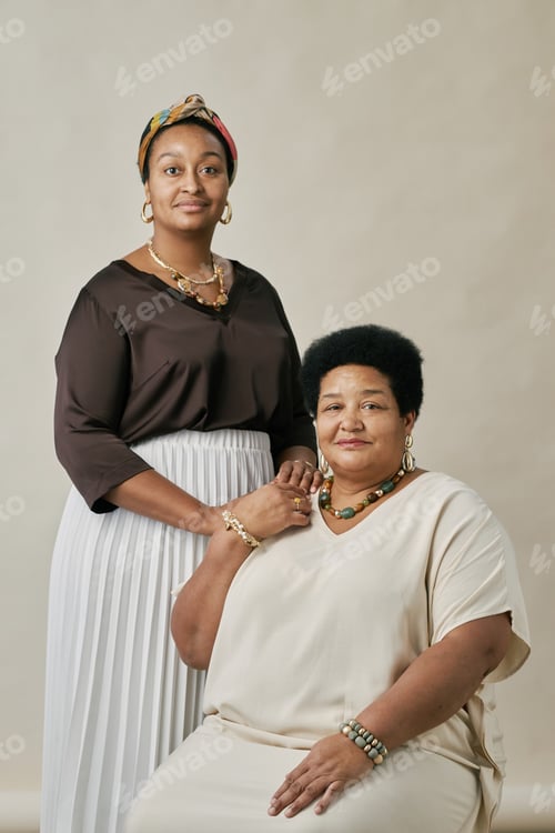 Preview: Portrait of Two Women Holding Hands in Studio Setting