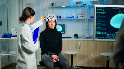 Preview: Stressed patient sitting on neurological chair with eeg headset